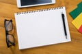 Laptop with paper, blank notepad and pencil on old wooden table. Royalty Free Stock Photo