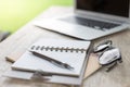 Laptop, Pen, notebook, glasses on the wooden table Royalty Free Stock Photo