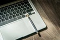 Laptop and pen. Office desk high angle view. Working from home. Selective focus included