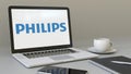 Laptop with Philips logo on the screen. Modern workplace conceptual editorial 3D rendering