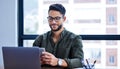 Laptop, phone and businessman with glasses in office for creative project with copywriting. Smile, technology and