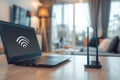 The laptop is placed on the table next to the wifi router