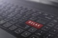 Laptop red keyboard button with word relax, rest time concept