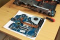 Laptop repair, motherboard with processor cooling system on table