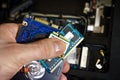 Laptop Repair. Upgrading laptop to new components. Hand of service engineer holds electronic boards for notebook. HDD, wifi