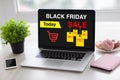 Laptop with sale black friday on screen and phone