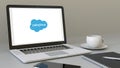 Laptop with Salesforce logo on the screen. Modern workplace conceptual editorial 3D rendering