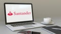 Laptop with Santander Serfin logo on the screen. Modern workplace conceptual editorial 3D rendering