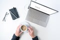 Laptop screen asking for input  and hands of an elderly woman are holding a coffee cup with a question mark reflection, white Royalty Free Stock Photo