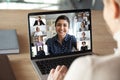 Laptop screen over woman shoulder view during group online communication