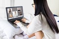 Laptop screen view over shoulder asian woman talking about work,sitting in bedroom make video call have distant communication