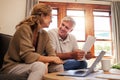 Laptop, senior couple and retirement planning with documents while sitting on sofa in the living room. Finance, budget Royalty Free Stock Photo