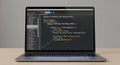 Laptop Showing Code on Screen - Front View, Desk Setting Royalty Free Stock Photo