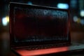 Laptop showing encrypted data on screen in dark environment Royalty Free Stock Photo