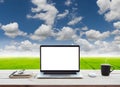 Laptop showing white screen on work table meadow and bl Royalty Free Stock Photo