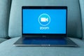 Laptop showing Zoom Cloud Meetings app logo.