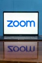 Laptop showing Zoom Cloud Meetings app logo.