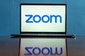 Laptop showing Zoom Cloud Meetings app logo.