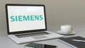 Laptop with Siemens logo on the screen. Modern workplace conceptual editorial 3D rendering