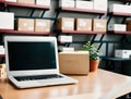 A laptop sitting on a desk in a warehouse with boxes and shelves in the background. Royalty Free Stock Photo