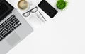 Laptop, smartphone, coffee cup, glasses, pen and pencil on white office desk table, top view, copy space, 3d rendering Royalty Free Stock Photo