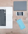 Laptop, smartphone and protective mask on the office Desk Royalty Free Stock Photo