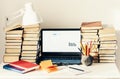 Laptop, stack of books, notebook, pencils in office background for education learning concept Royalty Free Stock Photo