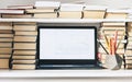 Laptop, stack of books, notebook, pencils in office background for education learning concept Royalty Free Stock Photo