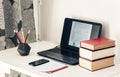 Laptop, stack of books, notebook, smartphone in office background for education learning concept Royalty Free Stock Photo