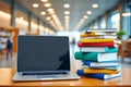 Laptop and Stack of Books on a Wooden Table in a Library A Scene of Learning Knowledge and Modern Education Royalty Free Stock Photo