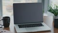 Laptop standing office desk close up. View wooden table with turned off computer Royalty Free Stock Photo