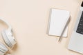Laptop and stationery on beige workspace, top view with copy space Royalty Free Stock Photo