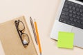 Laptop and stationery on beige workspace, top view with copy space Royalty Free Stock Photo