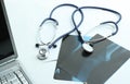 Laptop ,stethoscope and x-ray on the table Royalty Free Stock Photo