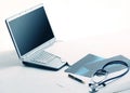 Laptop ,stethoscope and x-ray on the table Royalty Free Stock Photo