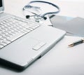 Laptop ,stethoscope and x-ray on the table Royalty Free Stock Photo