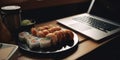 Laptop and sushi rolls with wasabi and soy sauce at workplace