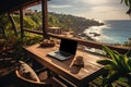 Laptop on table with beach and sea view, workplace while relaxing.