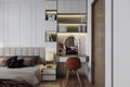 A laptop on the table with chairs, and books on the bookshelves in the bedroom