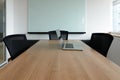 Laptop on table in corporate conference room Royalty Free Stock Photo