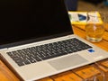 Laptop on table- with glass and paper Royalty Free Stock Photo