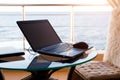 Laptop on the table on the hotel balcony with sea view. Remote work, doing business on vacation. Fast Internet, communication on