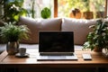 Laptop on a table surrounded by indoor houseplants