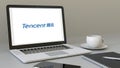 Laptop with Tencent logo on the screen. Modern workplace conceptual editorial 3D rendering