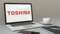 Laptop with Toshiba Corporation logo on the screen. Modern workplace conceptual editorial 3D rendering
