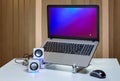 Laptop with USB speakers and wireless computer mouse Royalty Free Stock Photo