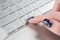 Laptop user finger pressing Windows icon key button on Microsoft Windows keyboard. Woman hand pressing Microsoft Windows key with Royalty Free Stock Photo