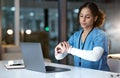 Laptop, watch and night with a black woman nurse working overtime on research in a hospital for healthcare. Computer Royalty Free Stock Photo