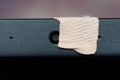A laptop webcam sealed for security reasons peeks out from behind the sticker. Issues of privacy, hacking and theft of personal Royalty Free Stock Photo