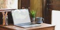 Laptop with white blank screen putting on old wooden desk. Royalty Free Stock Photo